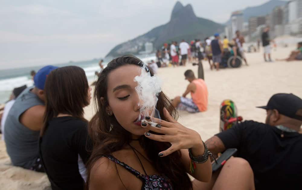 A woman smokes a marijuana joint during the 