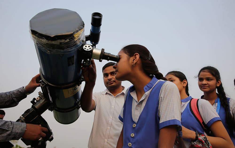 School children line up to look through a telescope the rare transit of Mercury across the sun in Lucknow. NASA says the event occurs only about 13 times a century. 