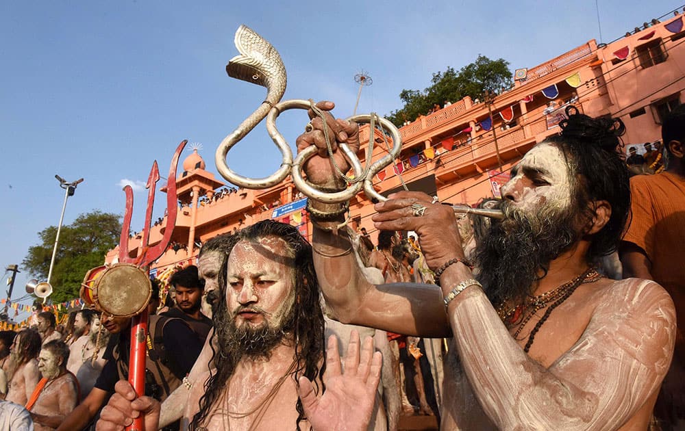 Naga Sadhu and devotees take part in the holy dip on the second Shahi Snan in Kshipra River during Simhastha Maha Kumbh Mela in Ujjain, Madhya Pradesh.