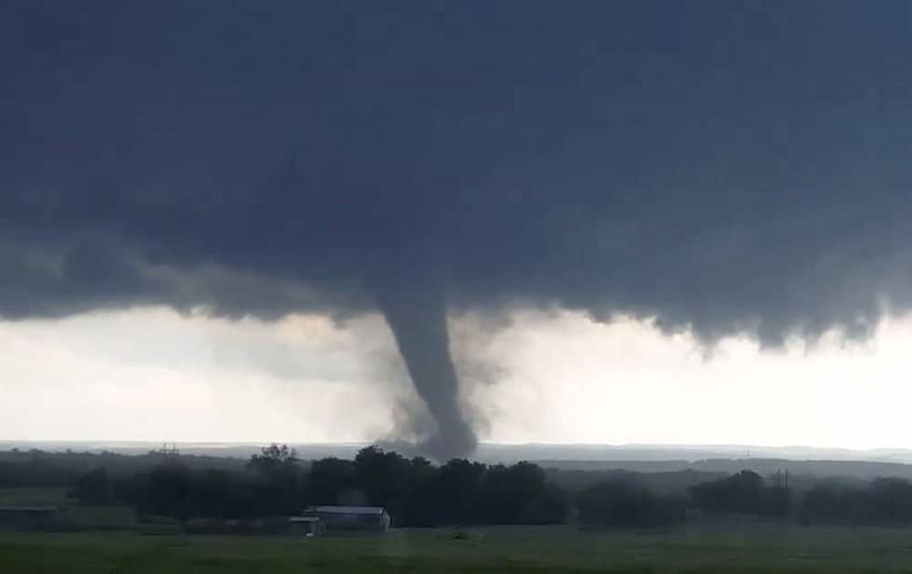 This image made from a video taken through a car window shows a tornado near Wynnewood, Okla.