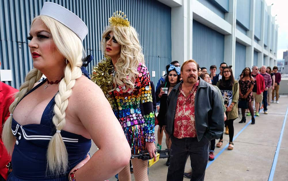 Ashley Galm Starr, left, waits in line with Ratchel Trailers, second from left, standing in line to attend RuPaul's DragCon at the Los Angeles Convention Center in downtown Los Angeles. 