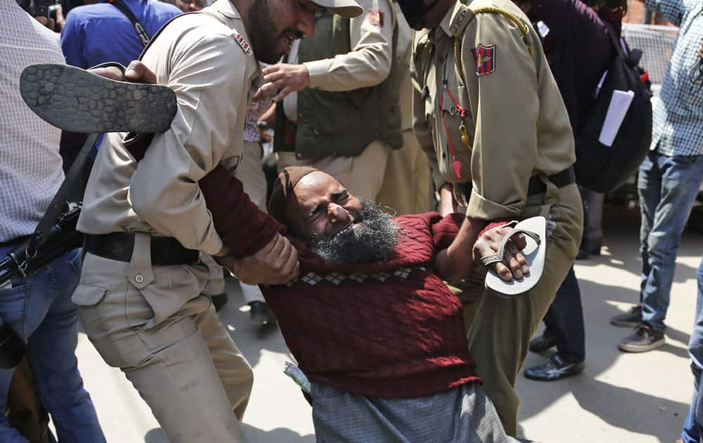  An activist of Jammu and Kashmir Handicapped Association is detained by police during a protest in Srinagar,Kashmir.