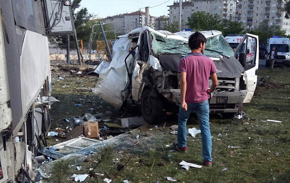 A security officer works at the explosion site after a car bomb struck a bus carrying Turkish police officers in the mainly-Kurdish city of Diyarbakir, Turkey.