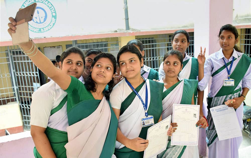 Class 10 students take a selfie while celebrating their success in the West Bengal Board of Secondary Education Examination at Balurghat in South Dinajpur district of West Bengal.