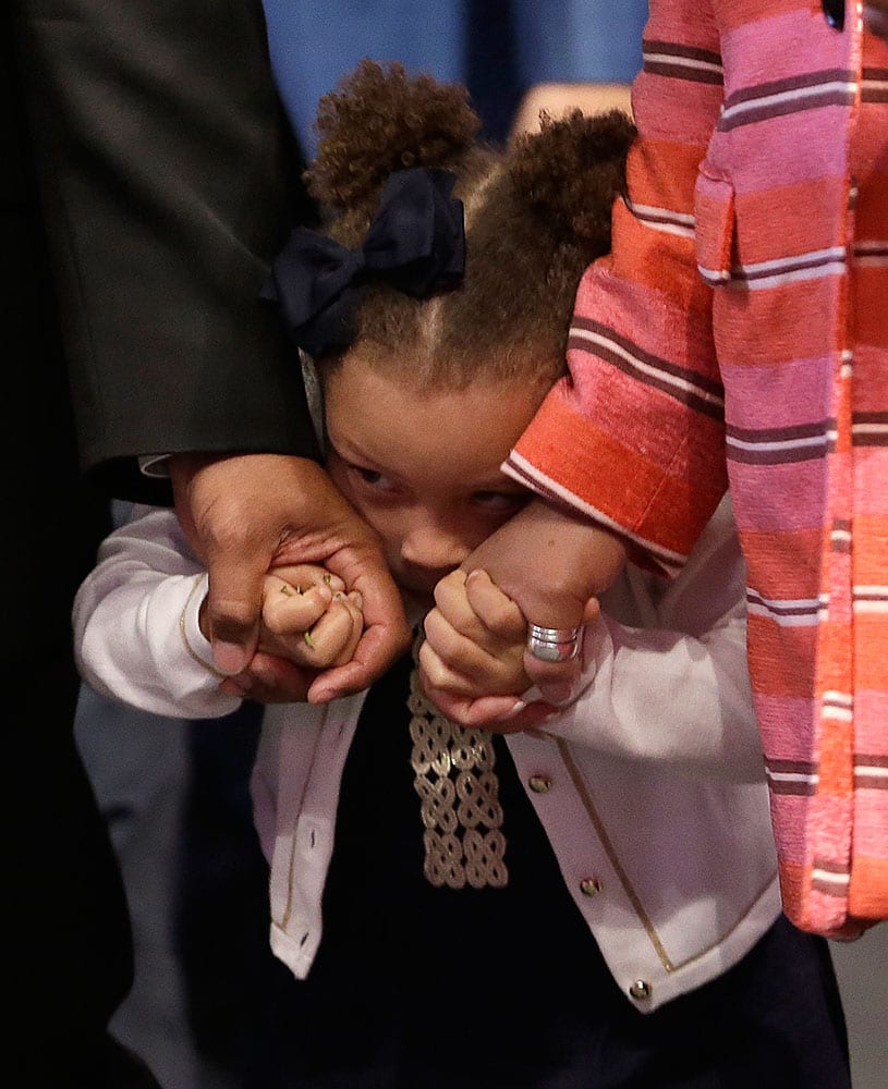 Riley Curry, daughter of Golden State Warriors guard Stephen Curry, hides as she enters the NBA's Most Valuable Player award presentation in Oakland, Calif. 