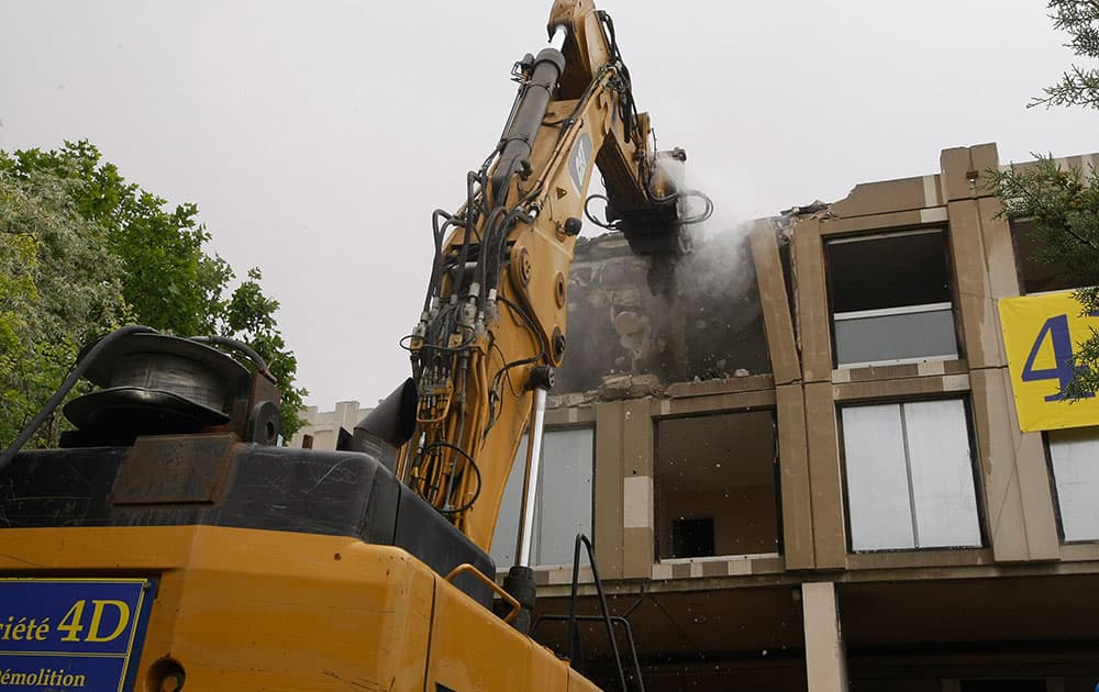 Construction workers demolish 