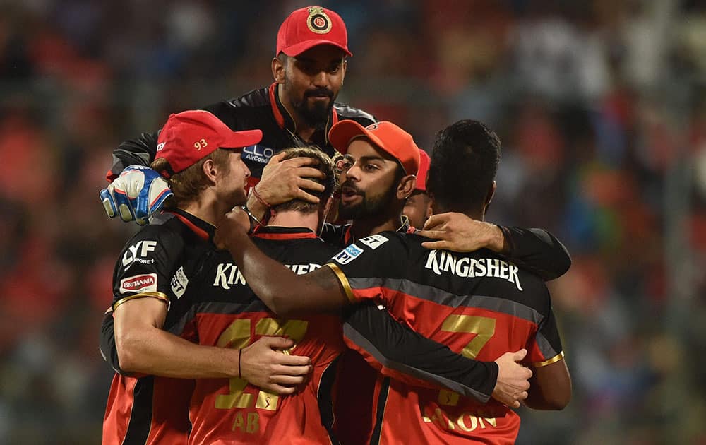 Royal Challengers Bangalore bowler Varun Aaron with team members celebrate the wicket of Ambati Rayudu during IPL 2016 match against Mumbai Indians at Chinnaswamy stadium in Bengaluru.