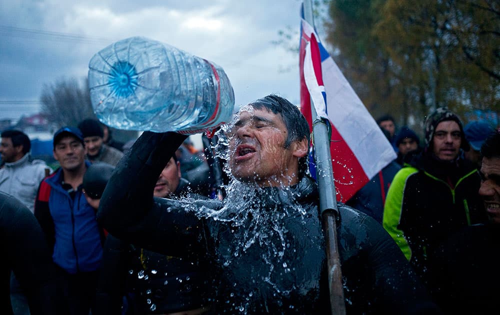 A diver throws water on his face during a protest march by shellfish divers in Chiloe Island, Chile.