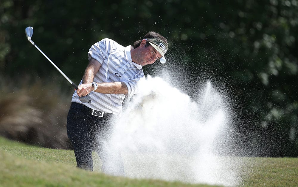 Bubba Watson hits from an 8th hole sand trap during the first round of The Players Championship golf tournament.