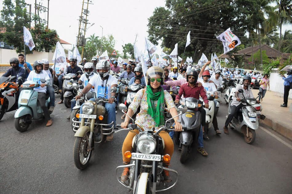 Actress and AAP leader Gul Panag leads a bike rally of the party in Panaji.
