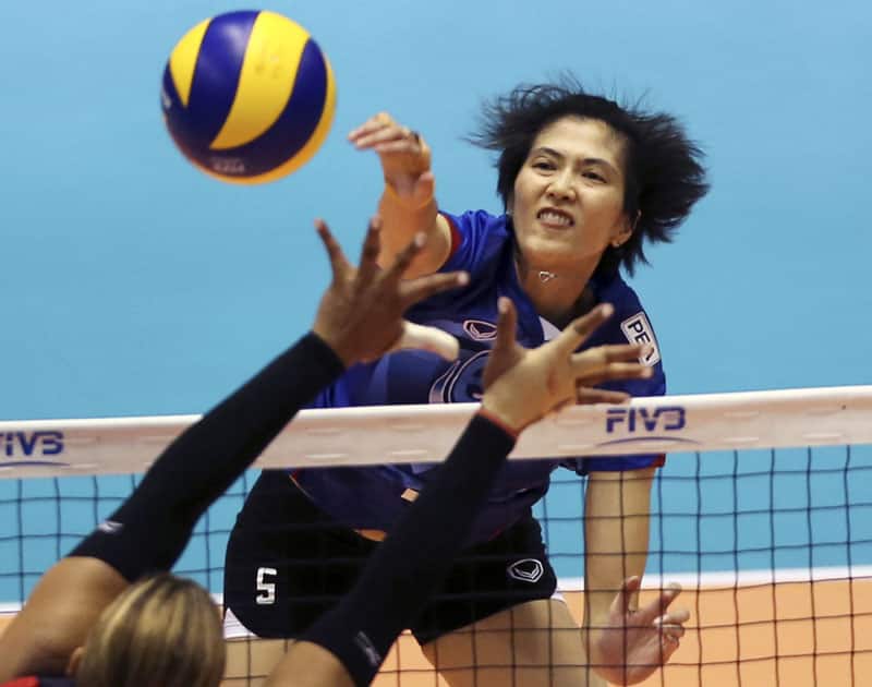 Pleumijt Thinkaow of Thailand spikes the ball against Dominica during their Women's Volleyball World Olympic Qualification Tournament in Tokyo.