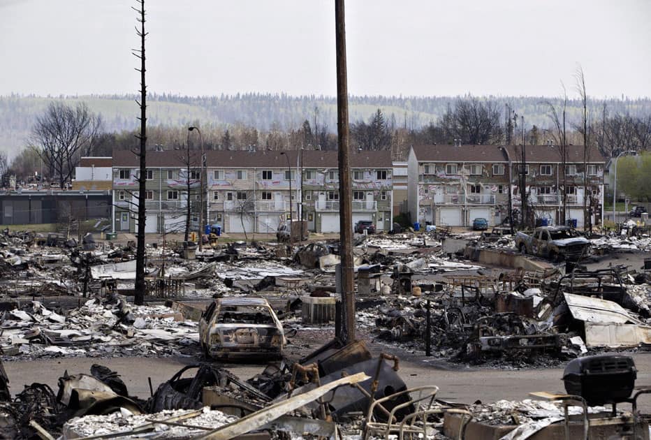 The charred remains of houses and vehicles litter the neighborhood of Abasand in wildfire-ravaged Fort McMurray, Alberta.