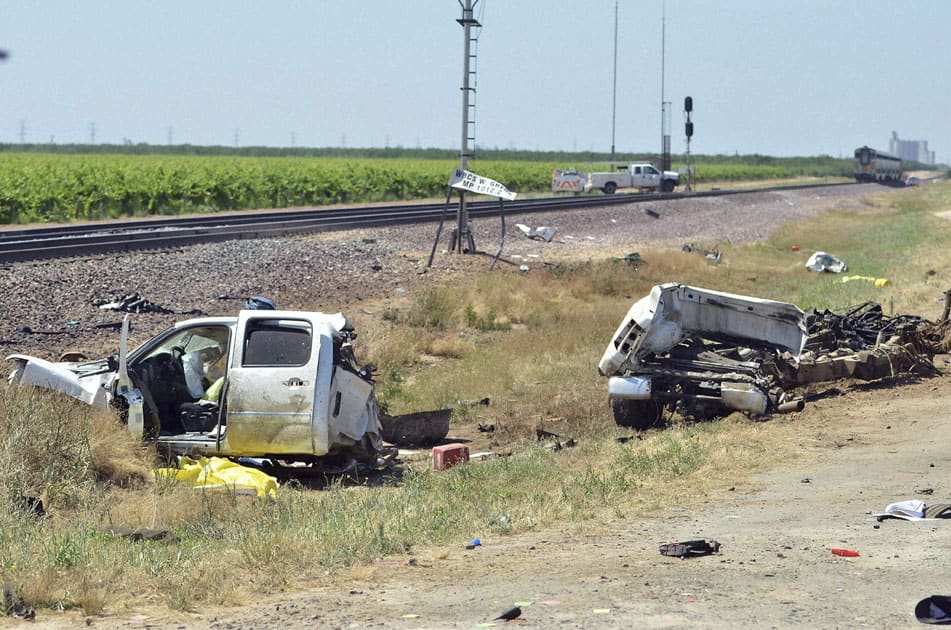 A pickup truck lies in pieces next to the train tracks after it was hit by an Amtrak train traveling westbound Friday,Calif. A few men in a pickup truck died when the driver pulled in front of a speeding Amtrak passenger train, splitting the truck in two but causing no serious injuries to the trains passengers.