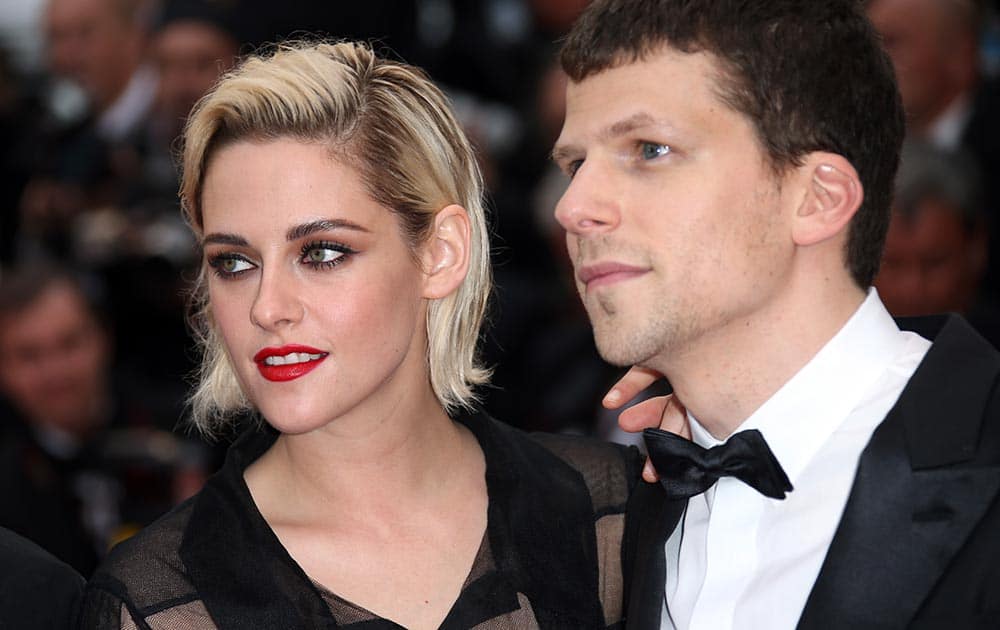 Actress Kristen Stewart, left and actor Jesse Eisenberg arrive on the red carpet for the screening of the film Cafe Society and the Opening Ceremony at the 69th international film festival, Cannes, southern France.