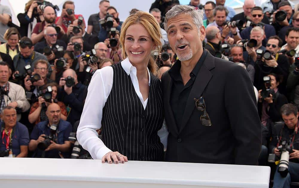 Actress Julia Roberts, left and actor George Clooney pose for photographers, during a photo call for the film Money Monster at the 69th international film festival, Cannes, southern France.