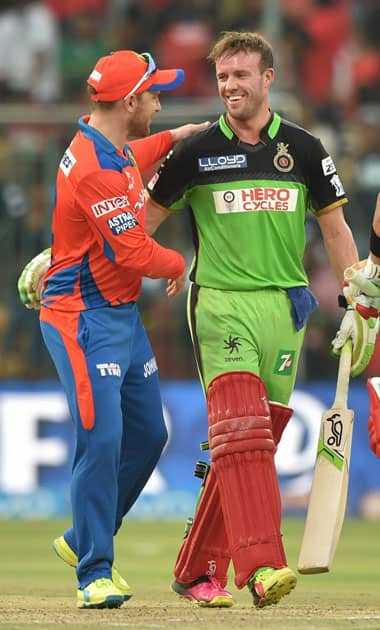  Royal Challengers Bangalore AB De Villiers being congratulated by Brendon McCullam during the IPL T20 match against Gujarat Lions in Bengaluru.