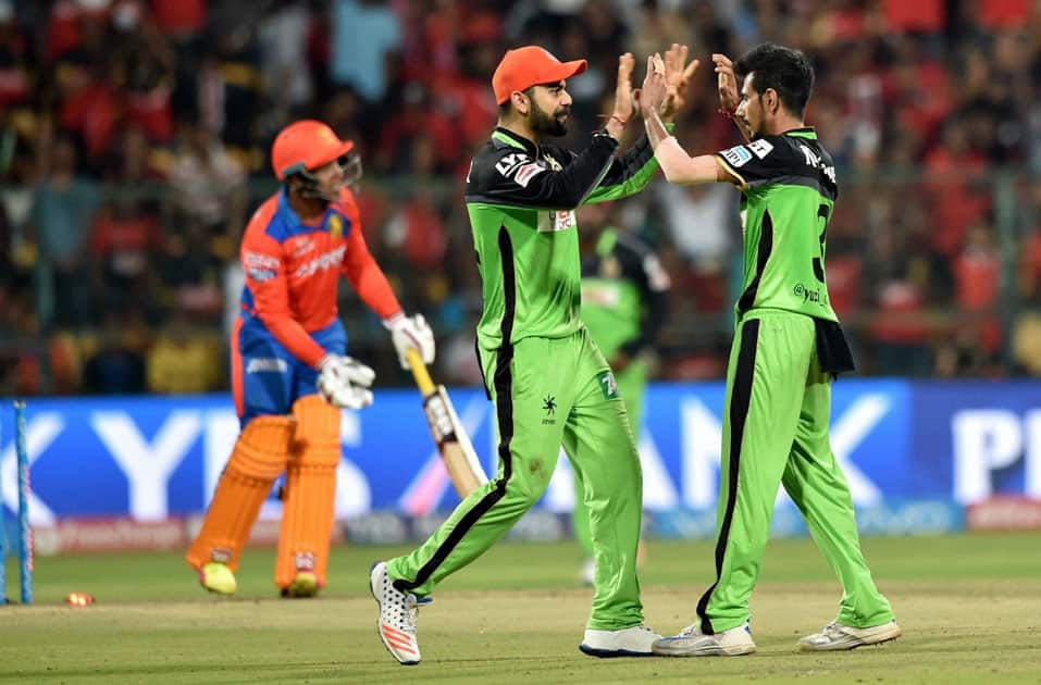 Royal Challengers Bangalore Yuzvendra Chahal with Virat Kohli celebrates the wicket of Akash during the IPL T20 match against Gujarat Lions in Bengaluru on Saturday.