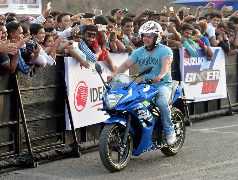 Bollywood actor Salman Khan rides a bike during the Suzuki Gixxer day in Mumbai.