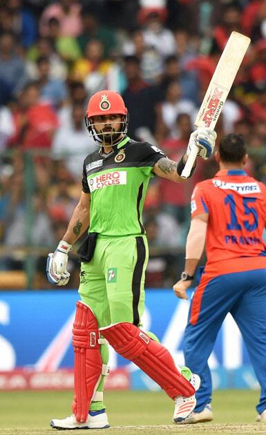 Royal Challengers Bangalore Virat Kohli celebrates his fifty runs during the IPL T20 match against Gujarat Lions at Chinnaswamy Stadium in Bengaluru.