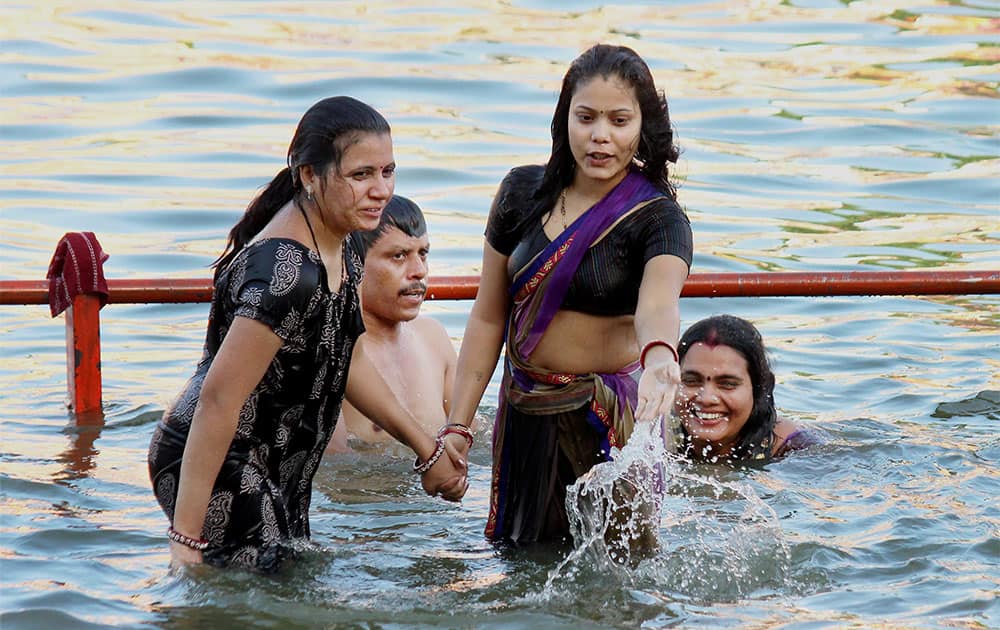 Devotees take bath in Kshipra River during Simahastha Mahakumbha Mela in Ujjain, Madya Pradesh.