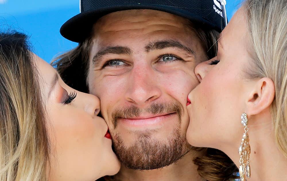 Peter Sagan, of Slovakia, gets kissed after winning stage one of the Amgen Tour of California cycling race, in San Diego.