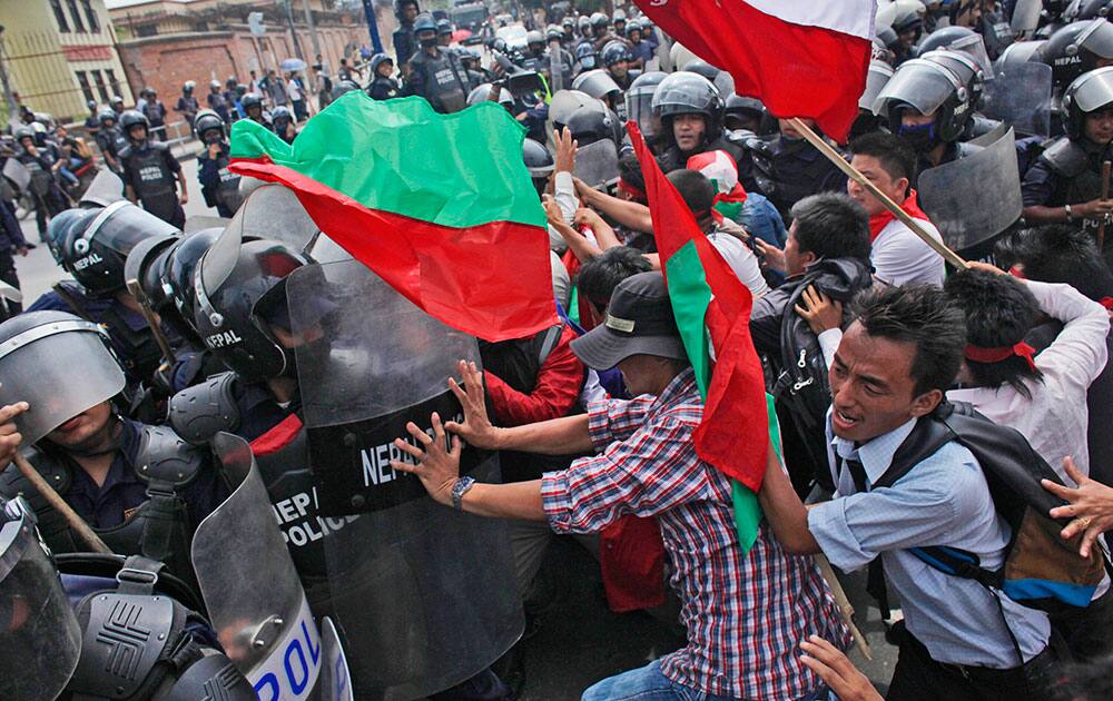 Supporters of Nepal's minority ethnic group scuffle with police as they try to march to the prime minister's office in Kathmandu, Nepal.