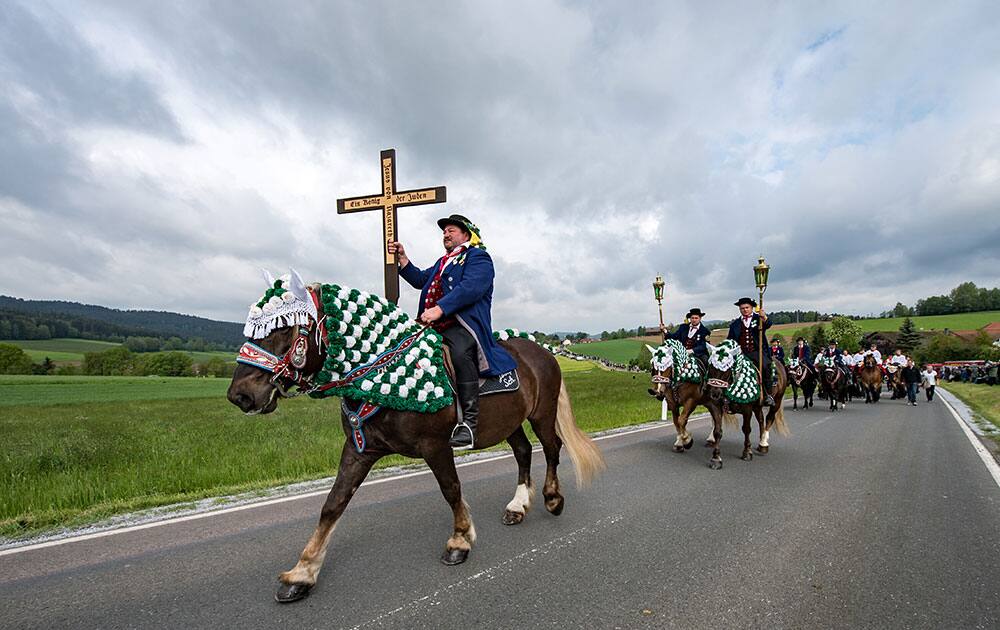 Participants of the Koetzing Pentecost Ride ride their horses near Bad Koetzing, Germany.