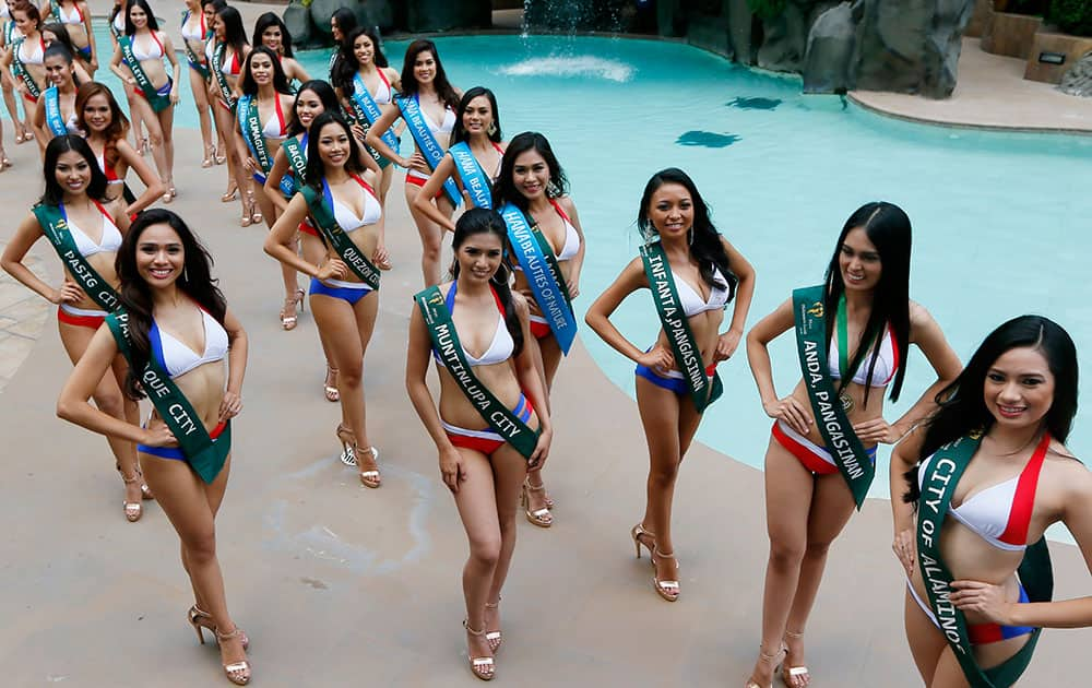 Contestants for this year's Miss Earth Philippines pose as they are presented to the media by the poolside of a hotel in Manila, Philippines. 