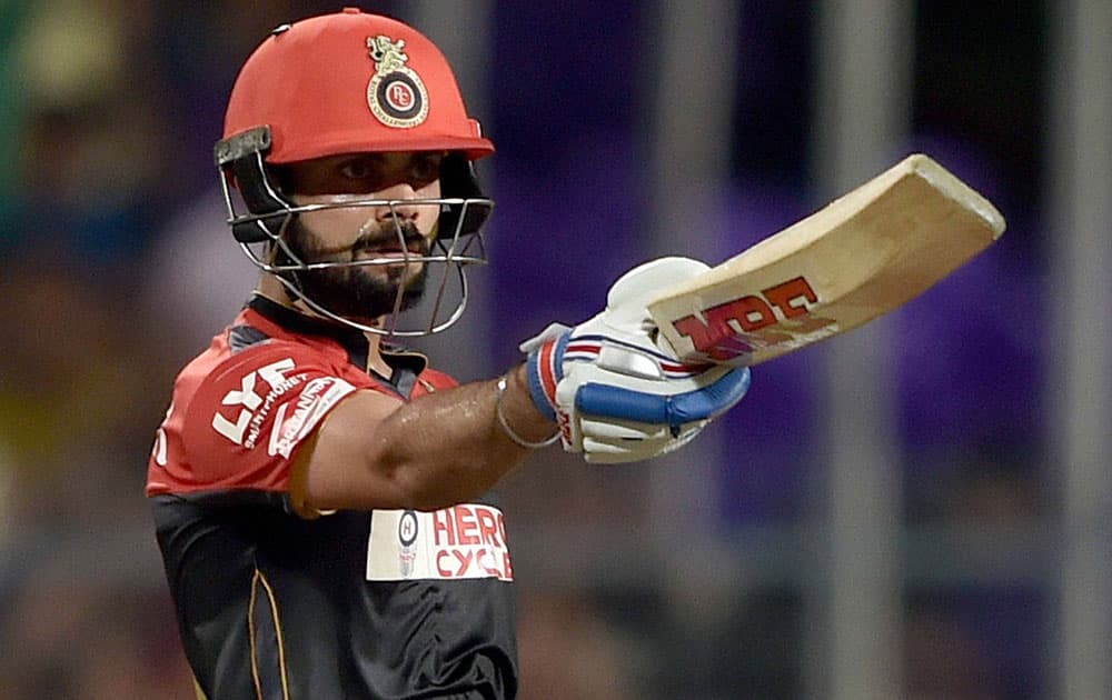 RCB batsman batsman Virat Kohli reacts after his half century during an IPL match against KKR at Eden Garden in Kolkata.