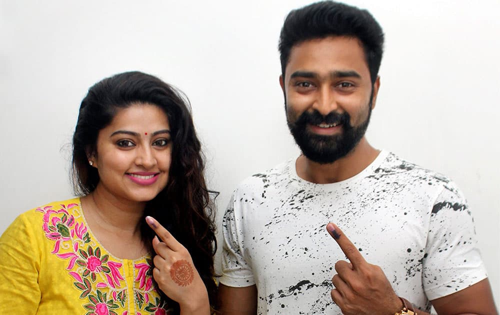 Actress Sneha and her husband actor Prasanna shows their ink marked finger after casting vote for Tamil Nadu Assembly polls in Chennai.