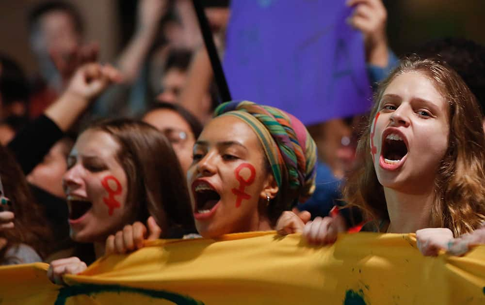 Women shout slogans during a protest against Brazil's acting President Michel Temer, and in support of Brazil's suspended President Dilma Rousseff, in Sao Paulo, Brazil.