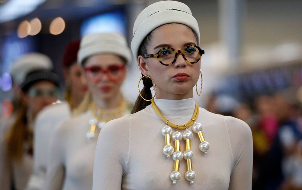 Models wear jewelry from Colombia's Natalia Criado's collection during Bogota Fashion Week, at El Dorado international airport in Bogota, Colombia.