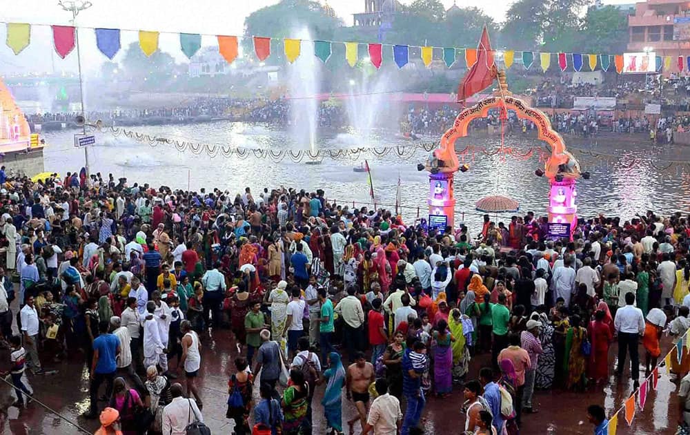 Devotees taking bath in Kshipra River during the Simhastha Mahakumbh in Ujjain, Madhya Pradesh.