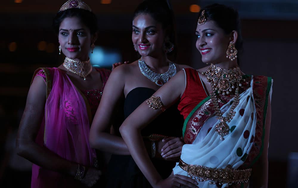 models display jewellery during a press conference to announce the 9th Hyderabad Jewellery, Pearl & Gem Fair.