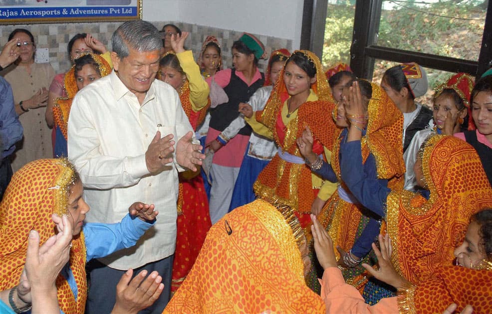 Uttarakhand chief minister Harish Rawat meeting with a group of children from a welfare council in Dehradun.