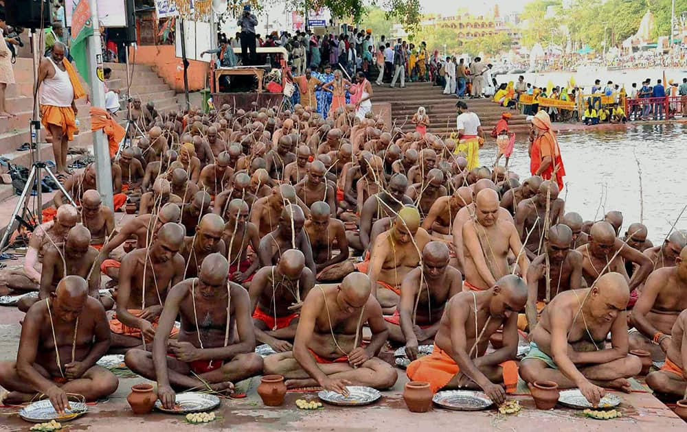 Sadhus of Niranjani Akhara take part in a Diksha ceremony at the banks of holy river Kshipra during Simhastha Maha Kumbh Mela in Ujjain, Madhya Pradesh.