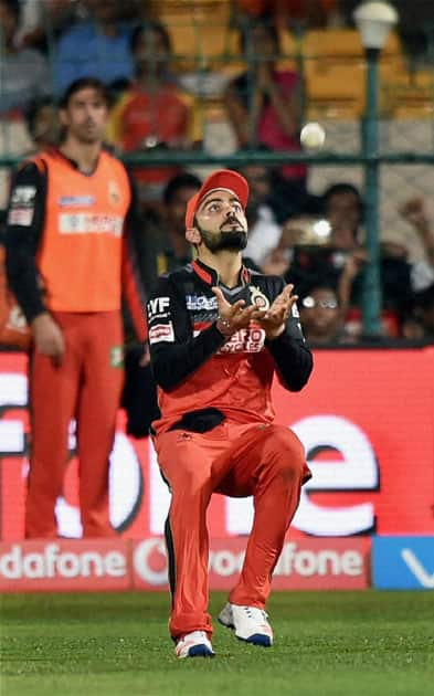 Royal Challengers Bangalores Virat Kohli takes a catch to dismiss Kings XI Punjabs Axar Patel during an IPL match at the Chinnaswamy Stadium in Bengaluru.