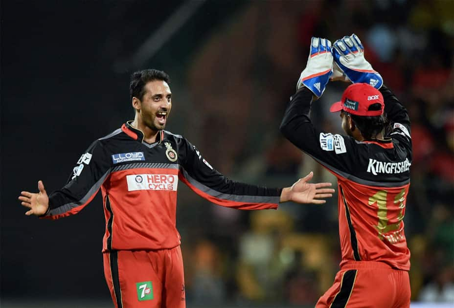 Royal Challengers Bangalores S Aravind with a teammate celebrates the wicket of Murali Vijay of Kings XI Punjab during the IPL match at Chinnaswamy Stadium in Bengaluru.