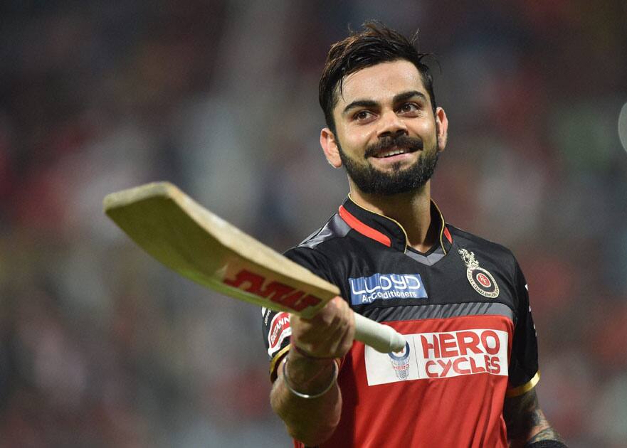 Royal Challengers Bangalores Virat Kohli celebrates his century during an IPL match against Kings XI Punjab at Chinnaswamy Stadium.