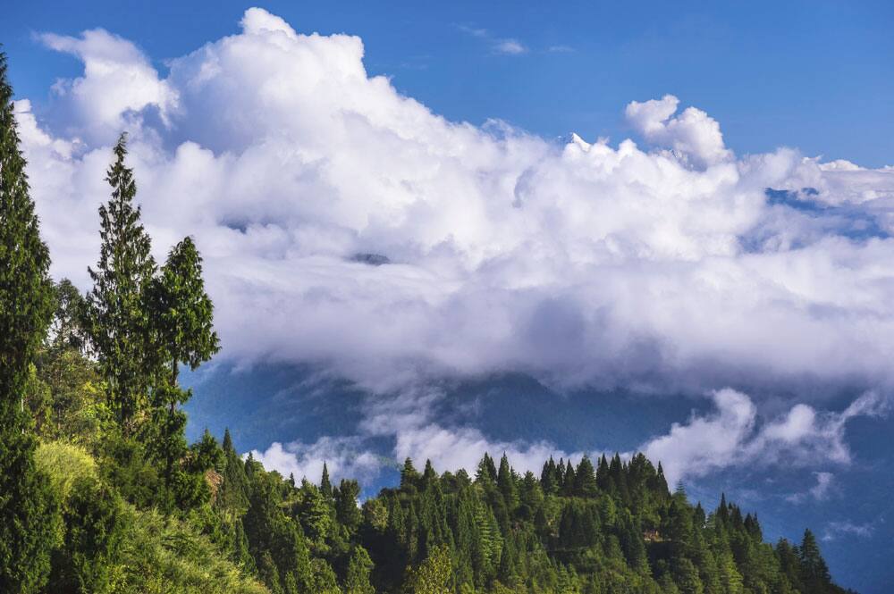 Spectacular white clouds cast a spell and the mighty mountain ranges forms the backdrop.