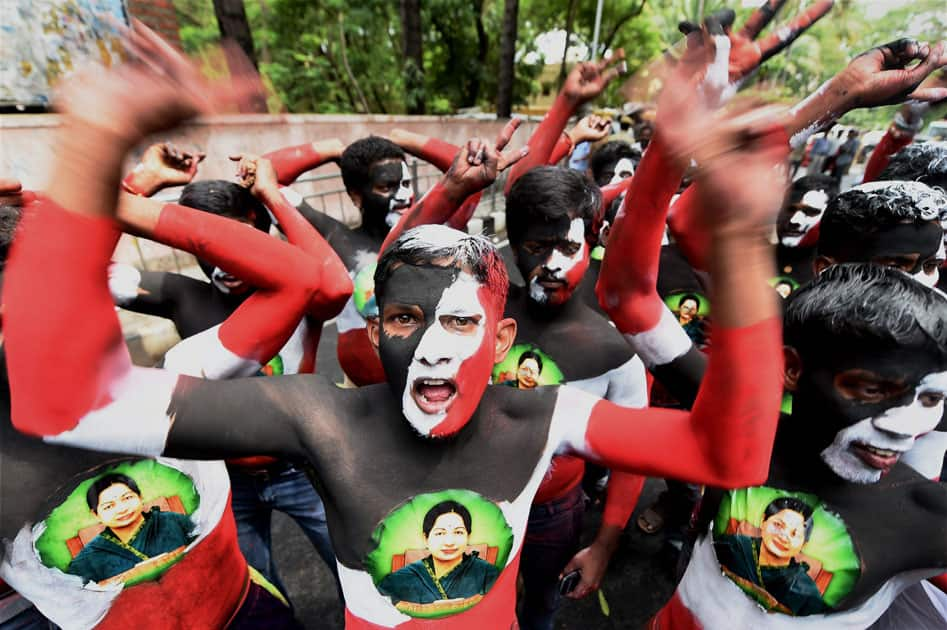 AIADMK cadres, with their bodies painted, celebrate the partys victory in the Assembly polls outside Chief Minister J Jayalalithaas Poes Garden residence in Chennai.