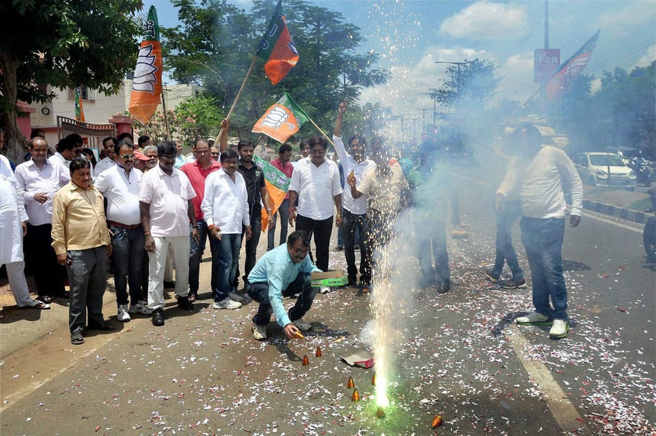 BJP workers burn crackers outside their party office as they celebrate winning of a seat in Kerala Assembly Elections, in Ranchi.