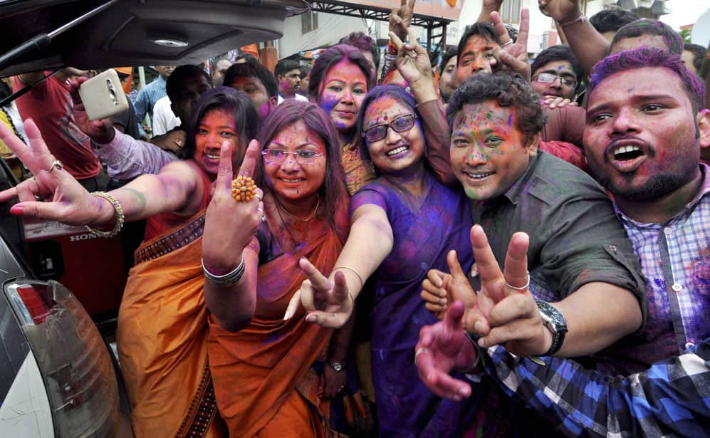 BJP workers dance as they celebrate their win in Assam Assembly election 2016 at Hengrabari in Guwahat.