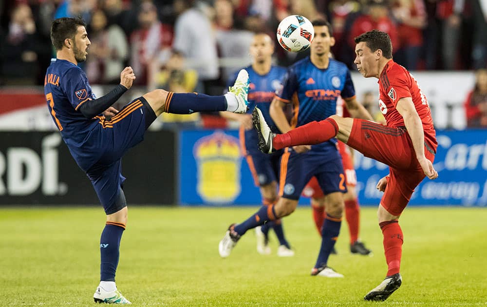 Toronto FC's Daniel Lovitz, right, battles for the ball with New York City FC's David Villa during the second half of an MLS soccer game against New York City FC, in Toronto. 