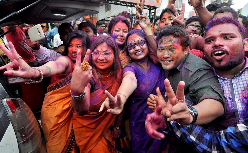 BJP workers dance as they celebrate their win in Assam Assembly election 2016 at Hengrabari in Guwahati.