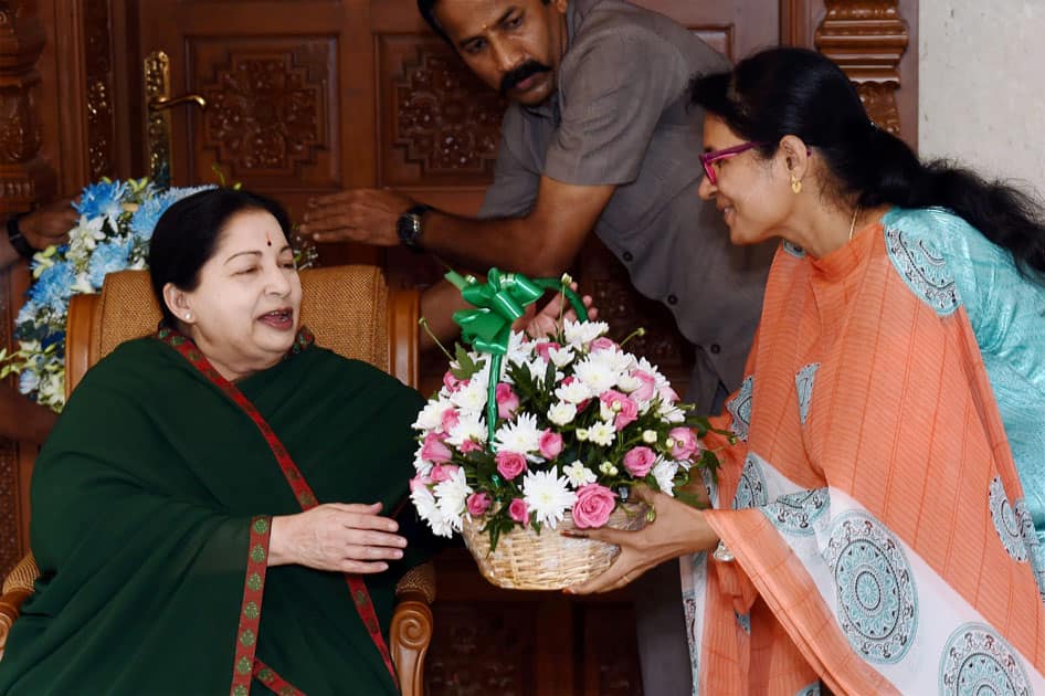 Tamil Nadu Chief Minister and AIADMK Supremo J Jayalalithaa receiving a floral bouquet from supporter after her partys win in the state Assembly polls, in Chennai.