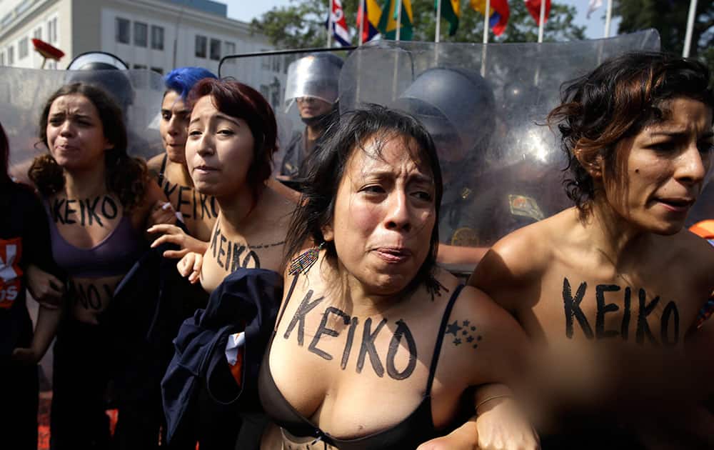 Demonstrators clash with riot police during protest against presidential candidate Keiko Fujimori in front of the congress building in Lima, Peru.
