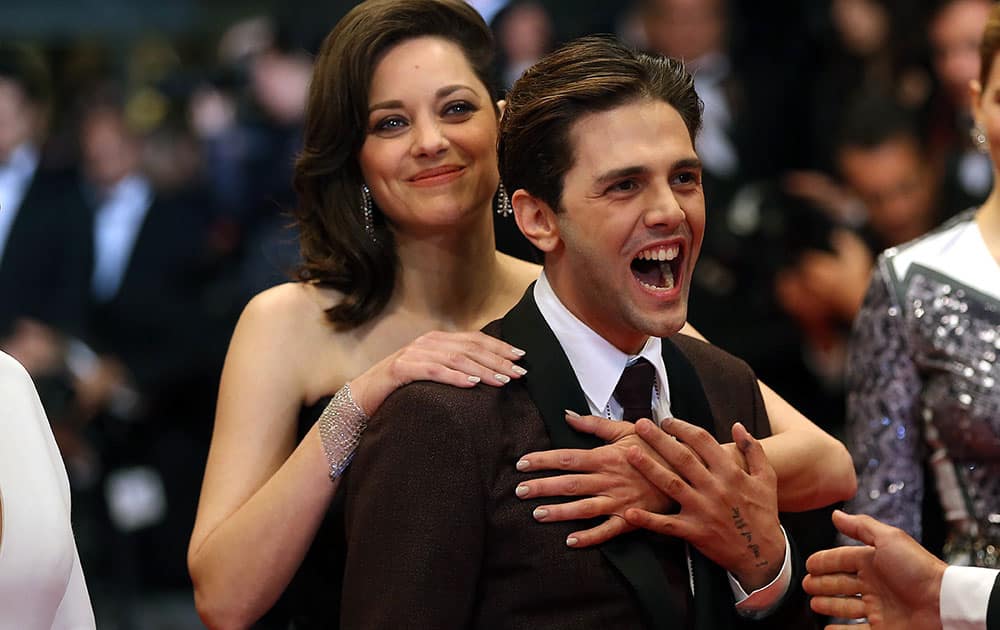 Actress Marion Cotillard and director Xavier Dolan pose for photographers upon arrival at the screening of the film Juste la Fin du Monde (It's Only the End Of The World) at the 69th international film festival, Cannes.