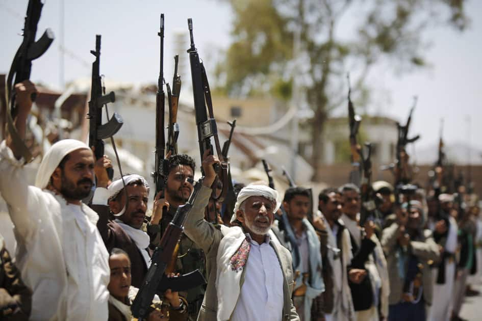 Shiite Houthi tribesmen hold their weapons as they chant slogans during a tribal gathering showing support for the Houthi movement, in Sanaa,Yemen.