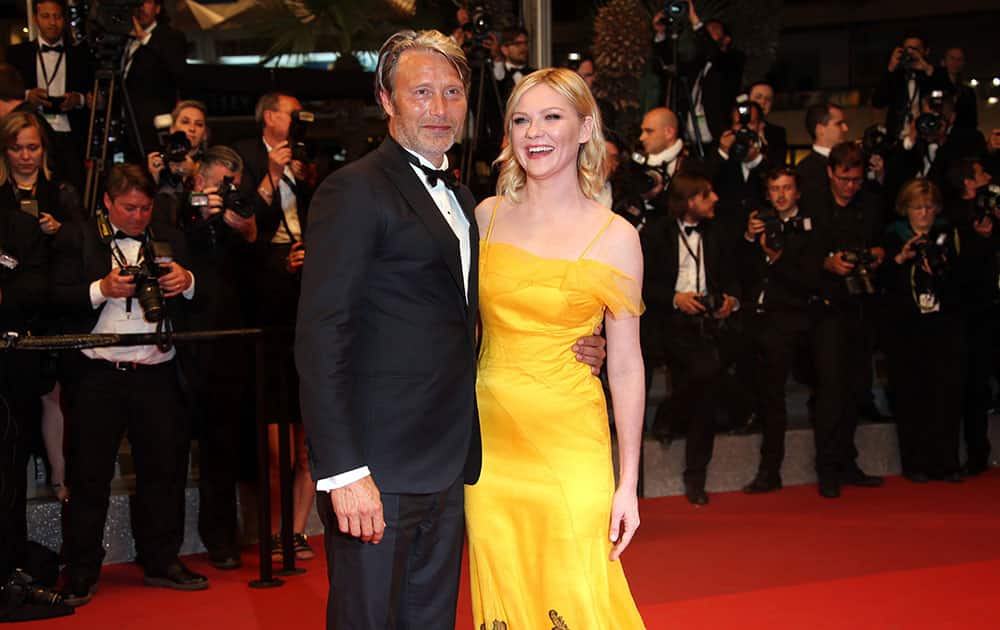 Jury members Mads Mikkelsen, left and Kirsten Dunst pose for photographers upon arrival at the screening of the film The Neon Demon at the 69th international film festival, Cannes, southern France.